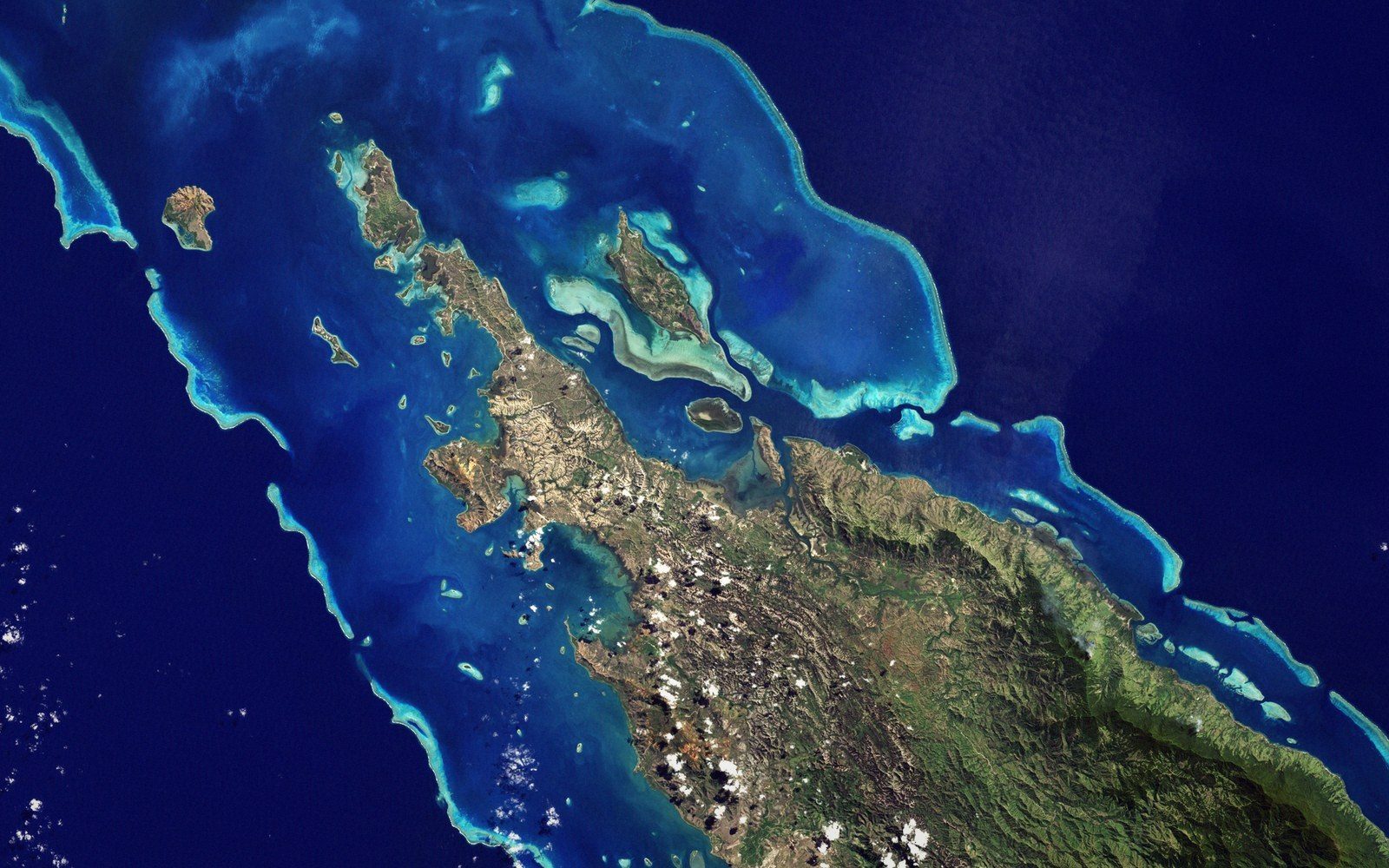 The lagoon from above with the reef line breaking white